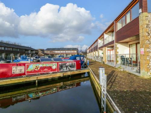 a boat is docked next to a building at 9 Swan House in Carnforth