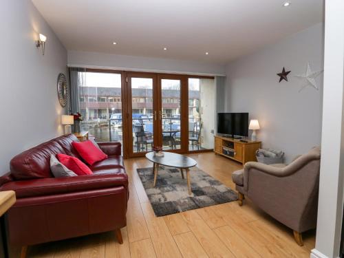 a living room with a couch and a table at 9 Swan House in Carnforth
