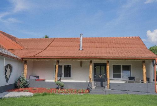 a house with an orange roof at Apartma in wellness Čista fantazija in Velika Polana