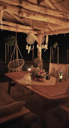 a wooden table with flowers on it in a room at Apartma in wellness Čista fantazija in Velika Polana