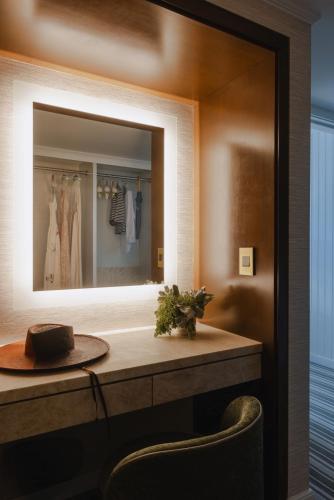 a dressing room with a mirror and a table at Regent Santa Monica Beach in Los Angeles