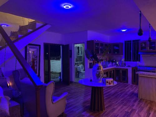a purple kitchen with a table in the middle of a room at Villa Tulum in San Cristóbal
