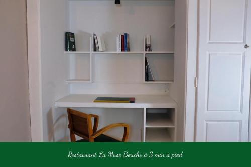 a desk in a room with a book shelf at La Verrière - Chambre d'hôtes et gîte de charme in Poligny