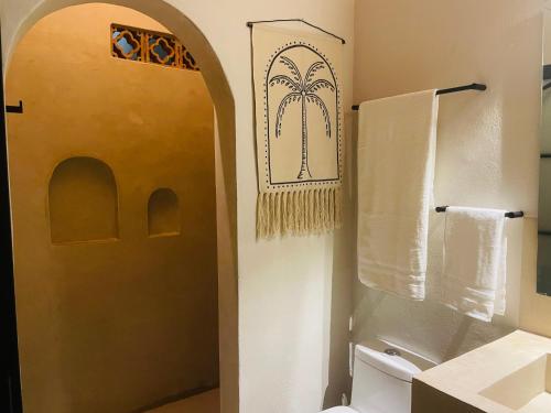 a bathroom with a shower and a toilet and a door at Casa Ceiba San Pancho in San Francisco