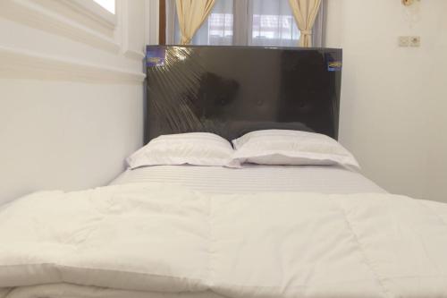Postel nebo postele na pokoji v ubytování Home Stay Pak Ndan dekat Masjid Ar-Rahman