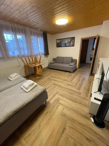 a living room with two beds and a couch at Pension Balm in Meiringen