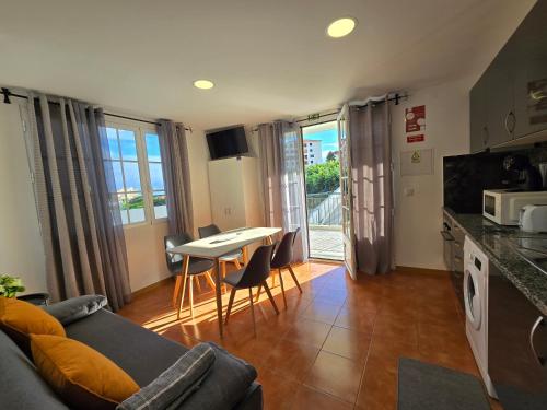 a living room with a couch and a table at Autonomia House I in Câmara de Lobos