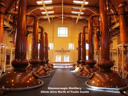 a room with a row of wine barrels in a building at Foulis Castle Gate Lodge in Evanton