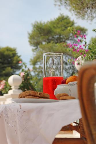 a plate of cookies and a glass of red liquid at Villa Margherita Art and Music in Marsala