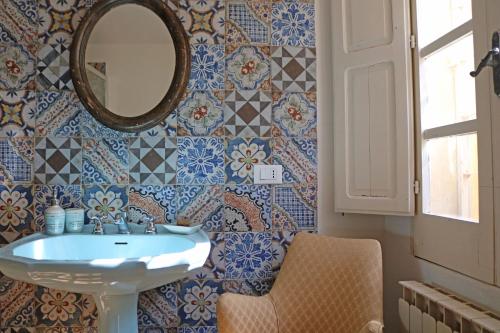 a bathroom with a sink and a mirror at Villa Margherita Art and Music in Marsala
