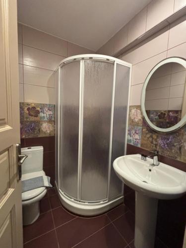 a bathroom with a shower and a sink and a toilet at SMILE in Platamonas