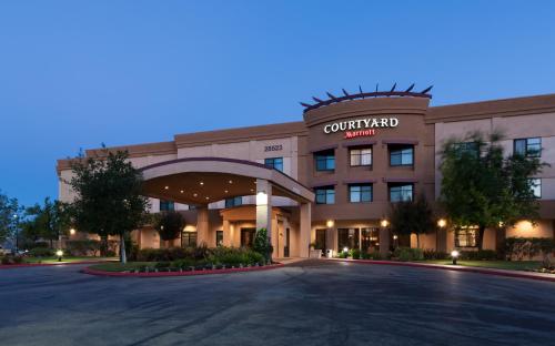 a rendering of a courtyard hotel at night at Courtyard by Marriott Santa Clarita Valencia in Valencia
