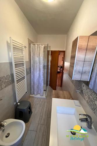 a bathroom with a sink and a toilet and a shower at Pratoranieri - Sparviero in Follonica