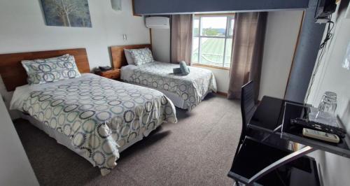 Uma cama ou camas num quarto em Hotel Terra Valdivia