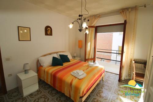 a bedroom with a bed and a balcony at Pratoranieri - Sparviero in Follonica