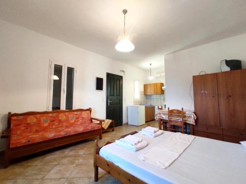 a living room with a bed and a couch at Zorgos Apartments in Zorgos 