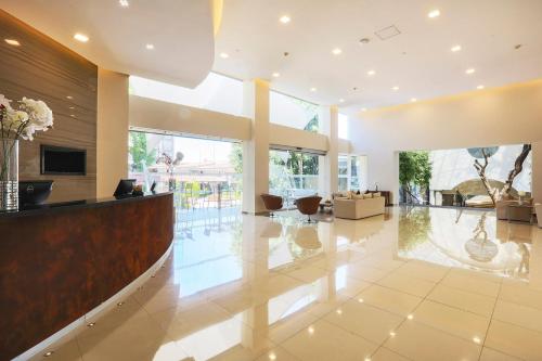 a lobby with a reception desk in a building at Krystal Satelite Maria Barbara in Mexico City