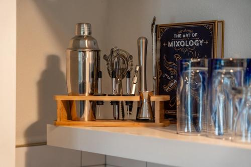 a shelf with a bunch of kitchen utensils on it at Pet friendly downtown studio! in Hot Springs