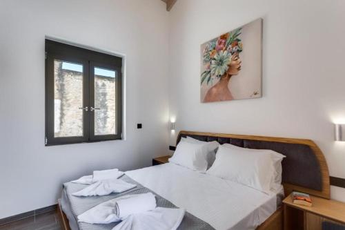 a bedroom with a bed and a window at Villa Archontiki in Kalamítsion Alexándrou