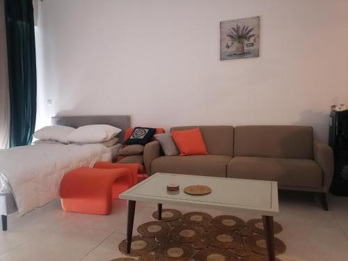 a living room with a couch and a table at Al RAHA village - Aqaba أستوديو بقرية الراحه العقبة مرسى زايد in Aqaba
