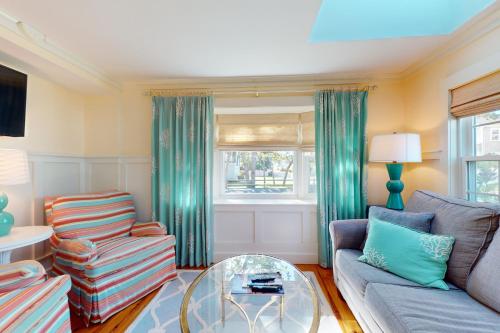 a living room with a couch and a glass table at Seaside Sanctuary in Harwich