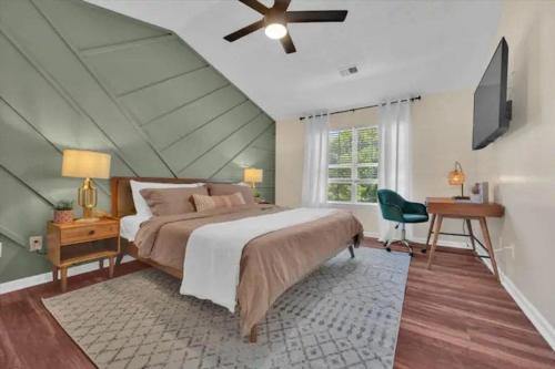 a bedroom with a bed and a ceiling fan at Family Home w FirePit GameRm Patio BbqGrill in Lilburn