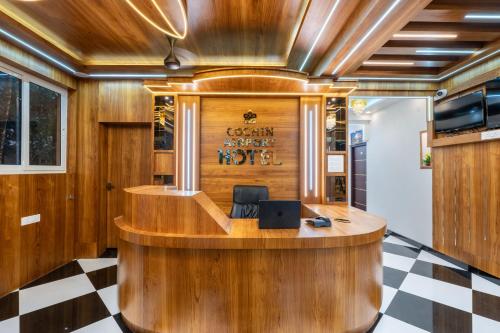 an office with a desk with a laptop on it at Cochin Airport Hotel in Ernakulam