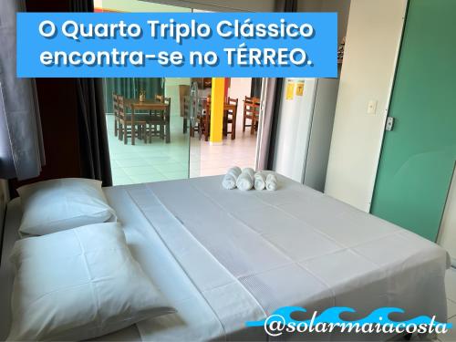 a bed in a room with a mirror at Pousada Solar Maia Costa in Atins