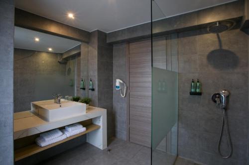 a bathroom with a sink and a shower at White Luxury in Thessaloniki