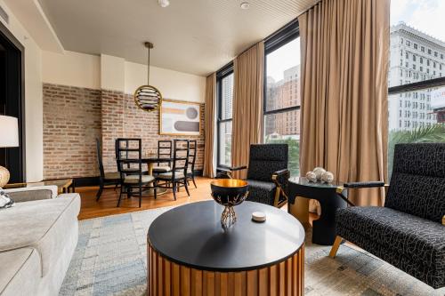 a living room with a couch and a table at The Mayfair in New Orleans