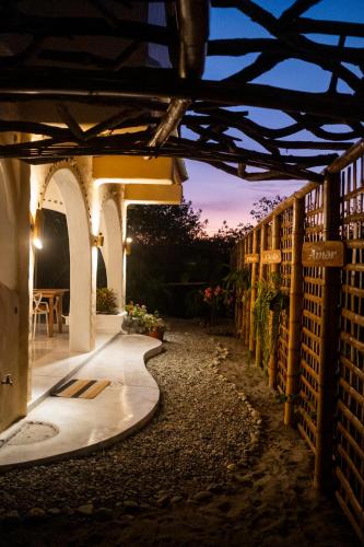 an outdoor walkway in a building at night at Tierra Munay in Las Tunas