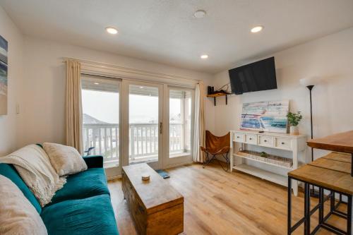a living room with a couch and a large window at Steps to Beach Corpus Christi Condo with Balcony in Corpus Christi