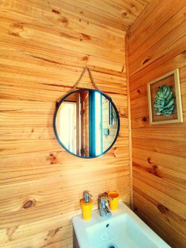 a bathroom with a mirror and a sink at Refugio Silvestre Parque Nacional Siete Tazas-Salida a río y pesca in El Bolsico