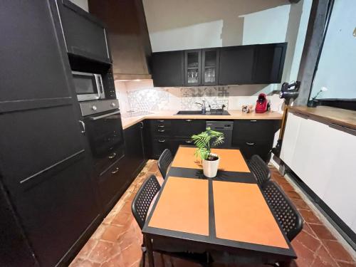 - une cuisine avec une table et une plante en pot dans l'établissement La baudinière, à Artannes-sur-Indre