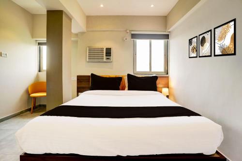 a bedroom with a large white bed in a room at Hotel O Siba Inn in Mumbai
