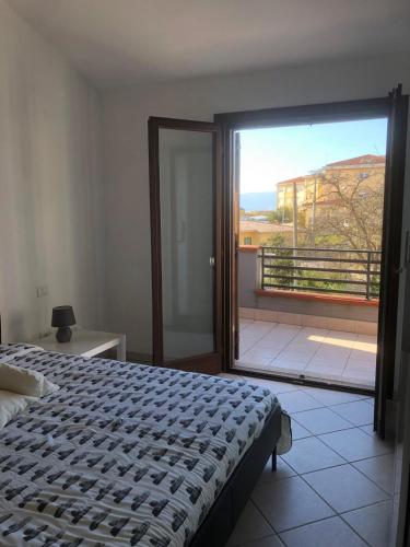 a bedroom with a bed and a view of a balcony at Casa Amabile in Sanluri