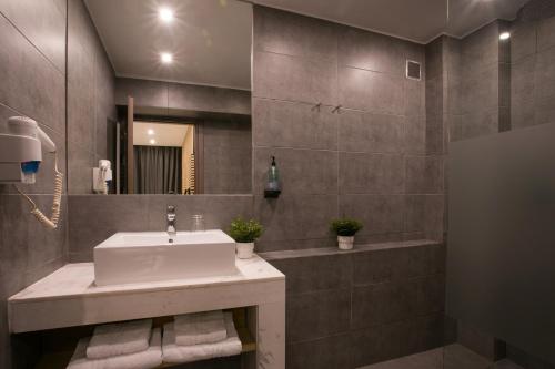 a bathroom with a sink and a mirror at White Luxury in Thessaloniki