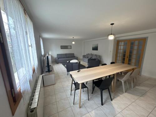 une salle à manger et un salon avec une table et des chaises dans l'établissement 130m T4 garden and car parks - Stade-Eurexpo-Lyon, à Meyzieu