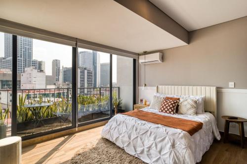 a bedroom with a large bed and a large window at Resort Home with Extraordinary City View in Mexico City