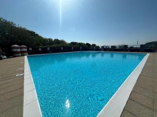 a swimming pool with blue water at Holiday Home with Private Hot Tub in Bembridge