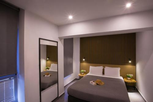 a bedroom with a bed with a mirror and a sink at White Luxury in Thessaloniki