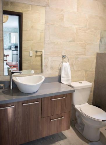 a bathroom with a white sink and a toilet at Vera Eco-Resort in Santa Emilia