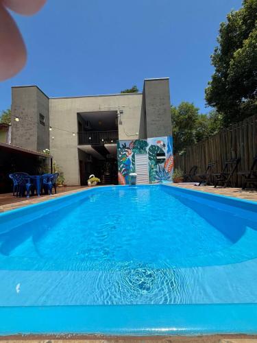 a large blue swimming pool in front of a building at POUSADA EIRU in Bonito
