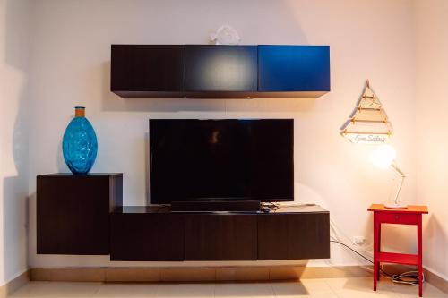 a living room with a flat screen tv on a wall at Charming & Family-Friendly Boqueron Village Condos! in Boqueron
