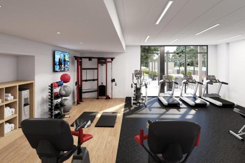 a gym with treadmills and cardio equipment in a room at Staybridge Suites Clermont Southeast by IHG in Clermont