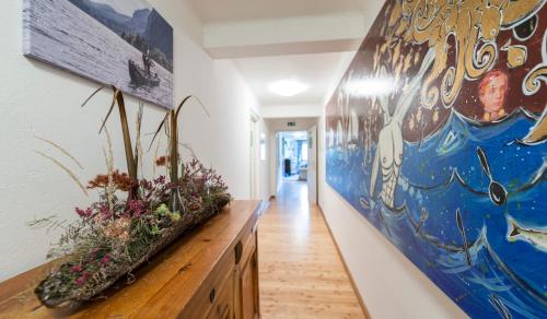 a hallway with a large painting on the wall at Landgasthof & Restaurant Batzenhäusl in Sankt Gilgen