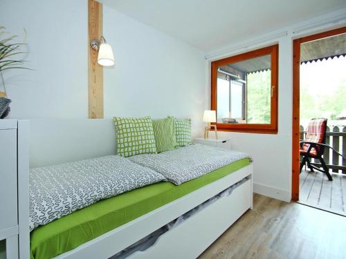 a white bedroom with a bed with a window at Bootshaus in Mirow mit überdachter Terrasse in Mirow