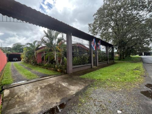 a fence with two flags on top of it at Villa tico House in Cariari