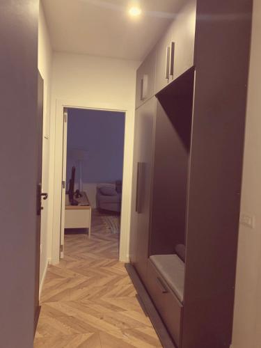 a hallway with a door open to a living room at Agoraapartment in Peje