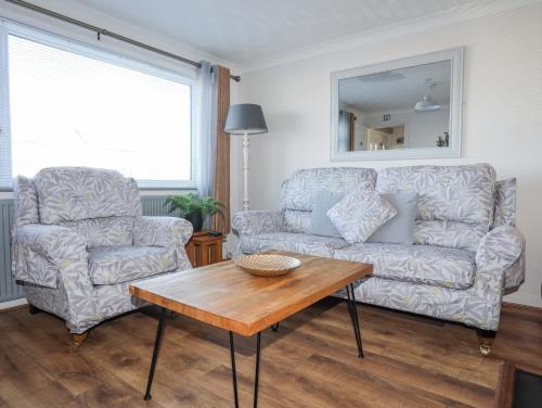 a living room with a couch and a table at Glasfryn in Holyhead